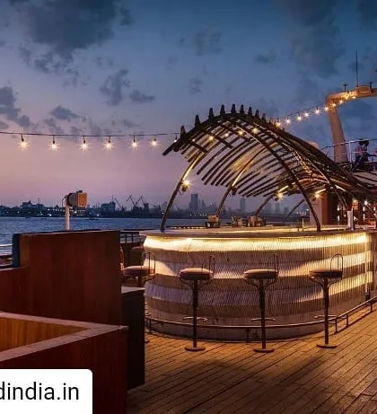 The open-air bar on the upper deck of the Queensline Sea Yah, designed to offer panoramic views of the Mumbai skyline. The skeletal structure above the bar is a custom sculpture inspired by a blue whale skeleton, anchoring the space with a distinct maritime identity.