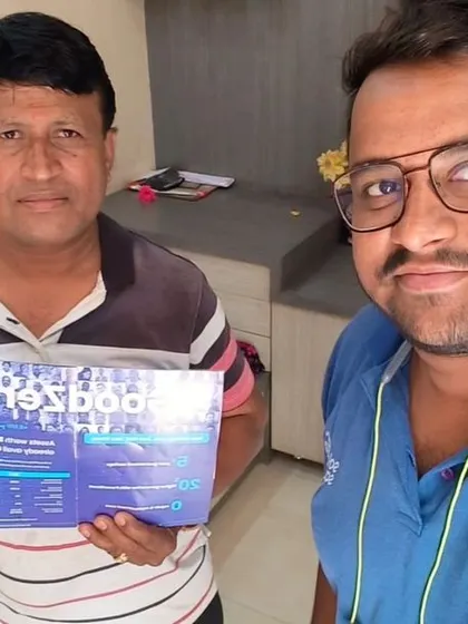 Our team member takes a selfie with a customer holding our "GoodZero" brochure.