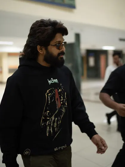 Allu Arjun on the move. The graphic hoodie paired with sunglasses creates an effortlessly cool airport look that’s perfect for a cross-country press tour.