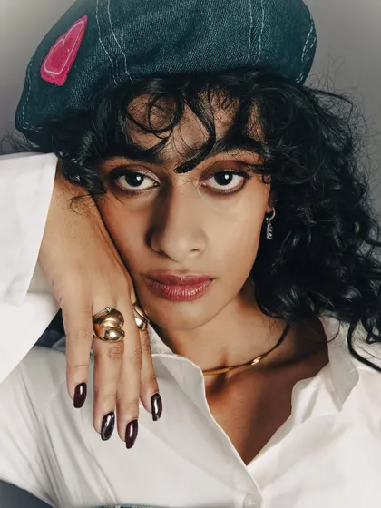 A beauty close-up from the series, focusing on the makeup, accessories, and the model's confident expression.
