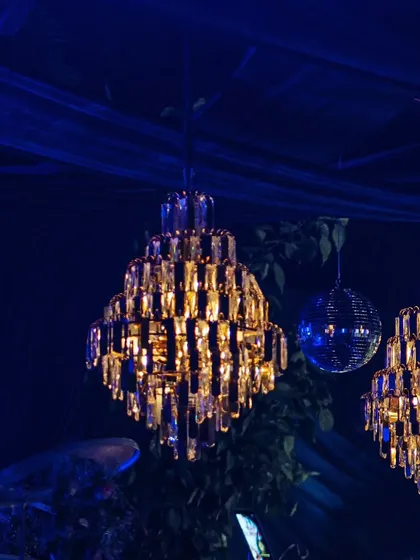 A close-up of the beautiful tiered crystal chandeliers that add a touch of glamour and luxury to the festive decor.