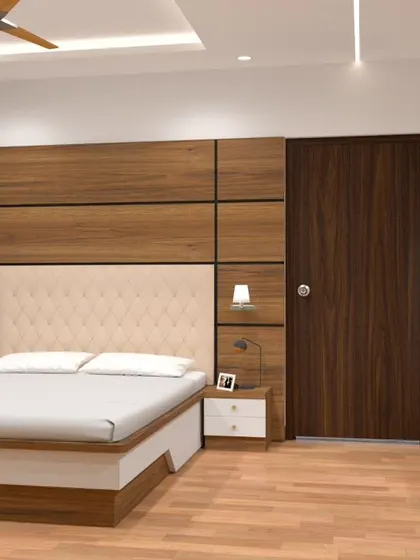A different view of the bedroom, showcasing the tufted upholstered headboard and a sleek dressing table with a large, round mirror against the green accent wall.