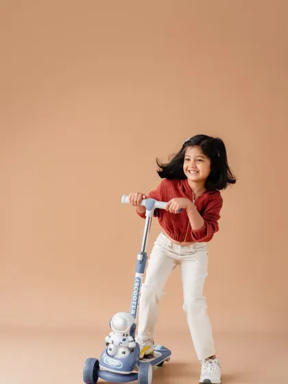 My daughter enjoying her scooter during our family photoshoot. Capturing her playful spirit and joy is something I'll always treasure.
