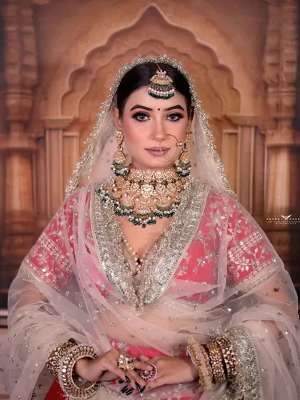 A direct and engaging portrait of the bride. Her confident gaze and the perfect symmetry of her look make this a powerful and captivating image.