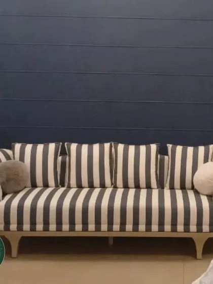 A classic sofa design reimagined with bold black and white vertical stripes. We built this piece with a gracefully curved frame and light wood legs, demonstrating our ability to execute both traditional and contemporary styles.
