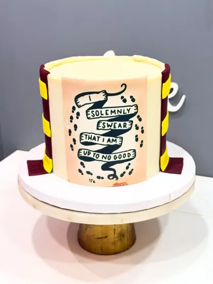 "I solemnly swear that I am up to no good." A magical Harry Potter cake for a true Gryffindor fan, featuring the Marauder's Map and a handmade Gryffindor scarf.
