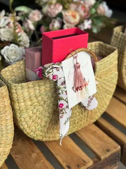 Bridesmaid gifting baskets ready for delivery. These handwoven baskets are filled with beautifully wrapped presents and adorned with a floral scarf and a "Will you be my bridesmaid?" tag.