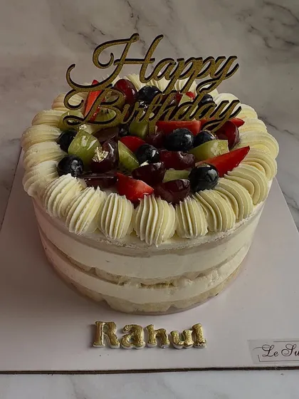 A celebration of summer's bounty. This Fresh Fruit Cake is loaded with seasonal fruits like strawberries, kiwis, grapes, and blueberries, all nestled in light vanilla cream.