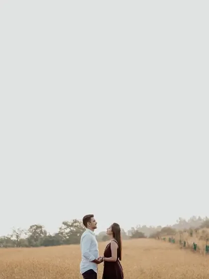 A beautiful wide shot using negative space to highlight the couple against the open sky and rolling hills.