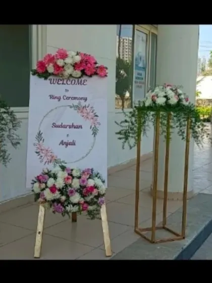 A welcome easel for a ring ceremony, decorated with fresh flowers to greet guests as they arrive.