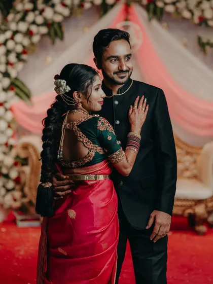 A beautiful couple photo, where the bride's custom green blouse with a detailed back design stands out.