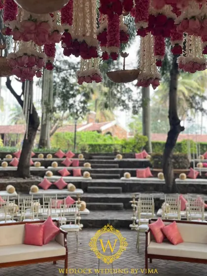 A glimpse into a stunning outdoor wedding we planned. The mandap was set in a courtyard amphitheater, with hanging floral tassels and elegant seating arrangements creating a romantic ambiance.