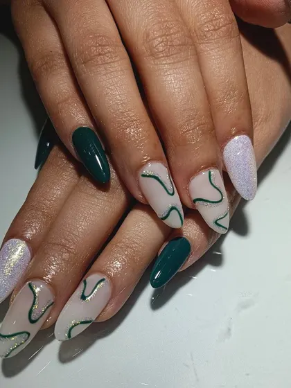 I love unique color choices. This gorgeous scheme combines deep green, shimmery lilac, and a nude base with abstract green swirl art.