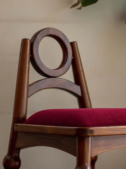 A series of images detailing the Manjadi chair, from its hand-turned legs inspired by the seed pod to the vibrant red upholstery. These shots highlight the craftsmanship and the deep cultural narrative behind this unique design.