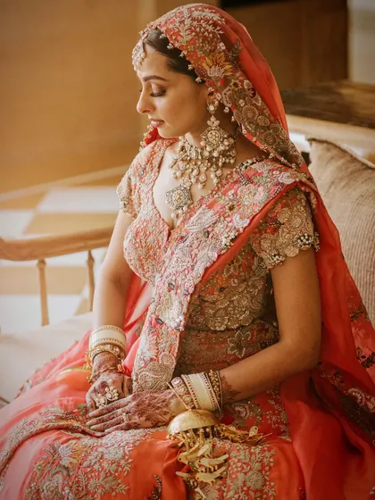 A serene portrait of the bride, capturing the intricate details of her Anamika Khanna lehenga.