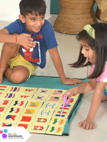 Two children happily collaborate on a geography puzzle, demonstrating how freedom to explore builds social skills and shared joy.