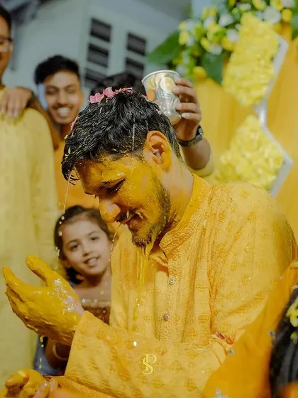 The groom enjoying the Haldi rituals, surrounded by smiling family members. I make sure to capture the groom's experience and joy just as much as the bride's.
