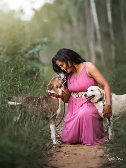 A duplicate of ID 41, this portrait of a woman embracing her two dogs is filled with the warmth and affection of a pet-loving family.