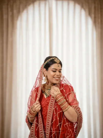 A stunning portrait of the Nikah bride in her traditional red attire, her happiness radiating.