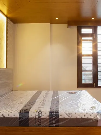 The morning sun highlights the beautiful textures in this master bedroom, from the backlit stone to the rich wooden bed frame. It’s a space designed to feel calm, clear, and completely yours.