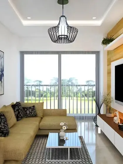 This compact living room is designed for comfort and style, featuring a cozy L-shaped sofa and a functional TV unit. The large sliding glass doors open to a balcony, filling the space with natural light and offering a view of the outdoors.