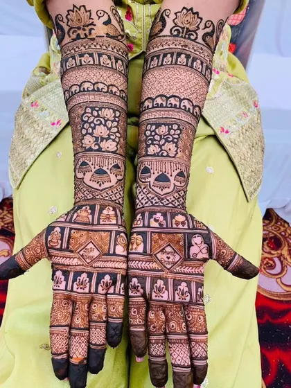 This design is packed with a variety of motifs, including peacocks, elephants, and floral patterns, creating a rich and celebratory look.