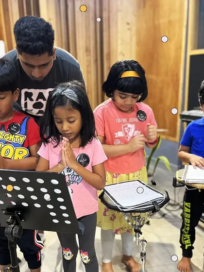 A group of our youngest students learning vocal warmups with their mentor. We teach them how to care for their voices and sing together in harmony.