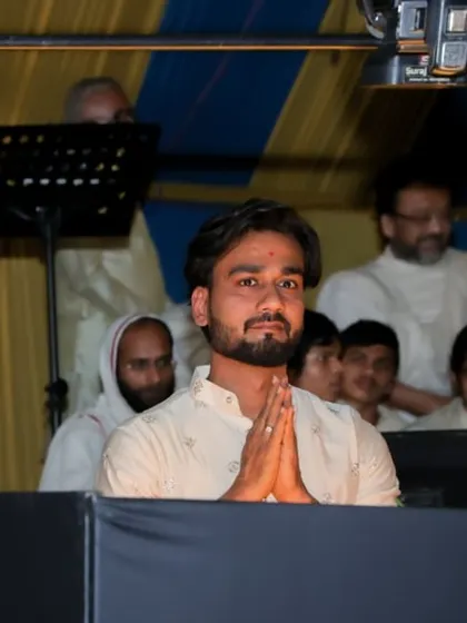 A moment of prayer and respect before my performance at Mahudi Tirth. The spiritual energy of such events is profoundly moving.