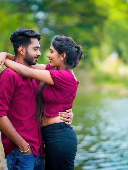 An intimate embrace by the water, capturing the couple's connection amidst a beautiful natural backdrop.