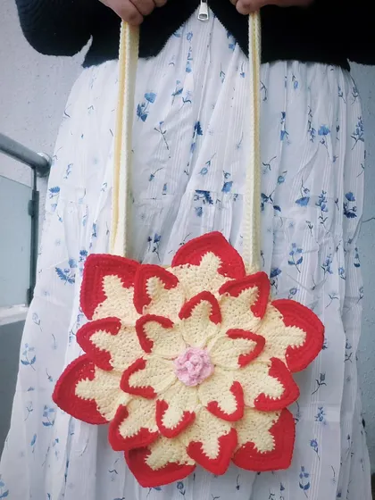 This is my custom-made Lotus Bag, a vibrant and playful shoulder bag that brings a pop of color to any outfit. The layered petal design is a great example of how I can turn a simple accessory into a piece of wearable art.