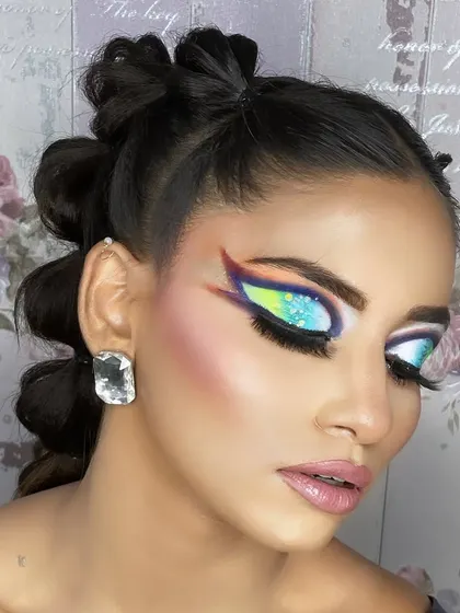 A hi-fashion makeup demo for my students. This look features bold, graphic shapes and a blend of vibrant colors, showcasing advanced techniques and creativity.