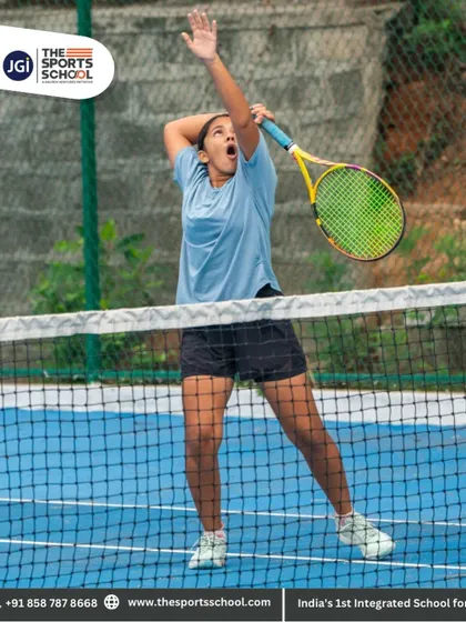 A female player practices her serve, a crucial weapon that we help our athletes develop and perfect.