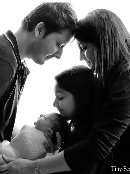 This is another take on the family portrait, showing the deep connection as they all focus on the baby. I take multiple shots to ensure we capture the perfect moment.