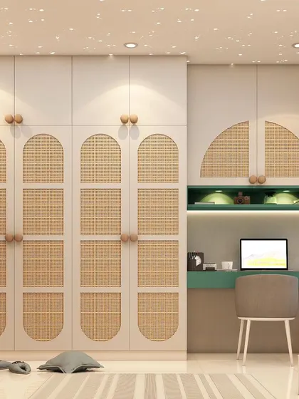 A functional and stylish kids' room featuring a wardrobe with cane-front doors and an integrated study desk. The natural textures and green accents create a calm and organized environment for both play and study.