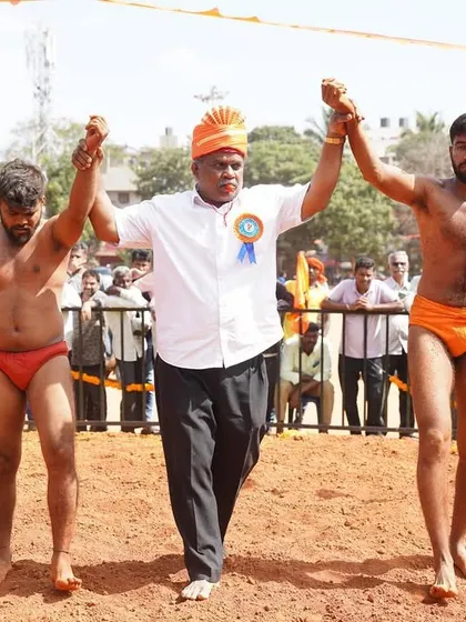 Raising the hands of the winner and runner-up. Respect is key in our tradition.