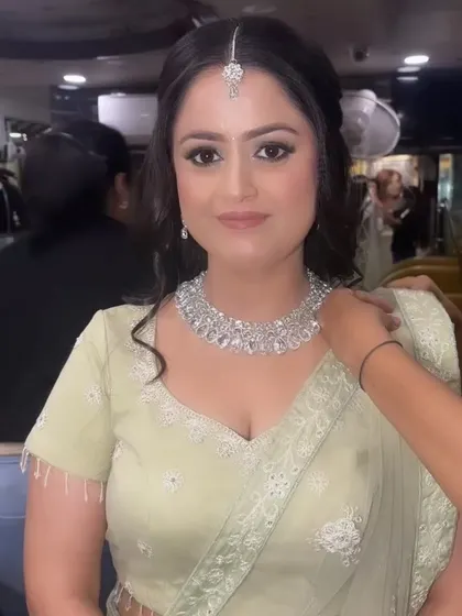 Our lovely Sagan bride getting her final touches. Her makeup is natural and radiant, with a simple maang tikka and diamond necklace completing the look.
