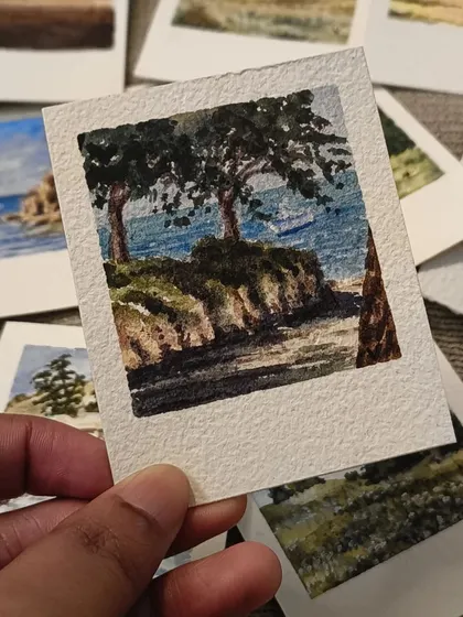 Two sturdy trees stand on a small cliff overlooking the water in this miniature watercolor painting. I use fine brushes to capture the details of the leaves and the texture of the earth.
