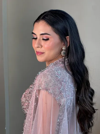 The sparkling pink eyeshadow is the star of this look. It’s a fun yet elegant choice that adds a beautiful pop of color for an evening event.