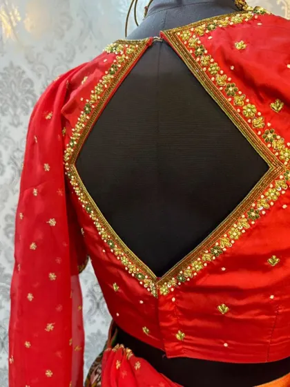 A back view of the blouse from the Patola lehenga set, showing the stylish diamond-shaped cutout.