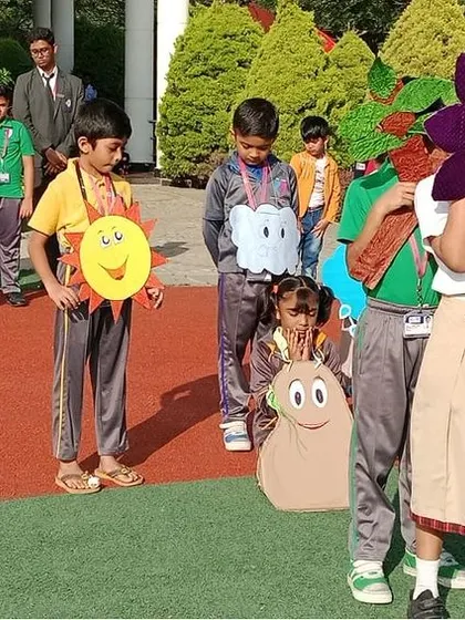 The performance culminates with a flower blooming, a delightful and visual lesson for the entire school.