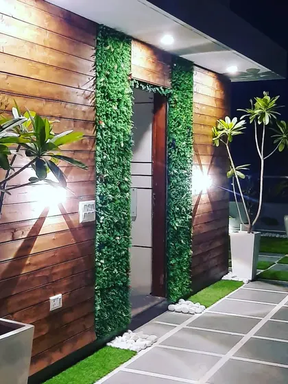 A close-up on the exterior finishes. We combine materials like natural wood and artificial green walls to add texture and visual interest to our structures.