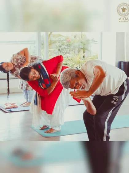 Laughter and joy are essential parts of our practice. Here, senior students share a lighthearted moment, reminding us that yoga is also about community and connection.