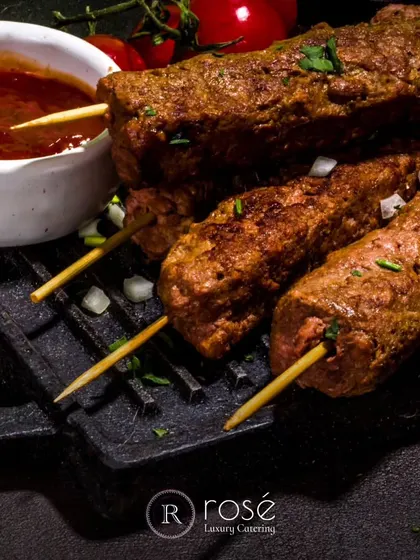 A close-up of succulent seekh kebabs, grilled to perfection. We use the finest ingredients and traditional spices to create authentic and flavorful dishes.