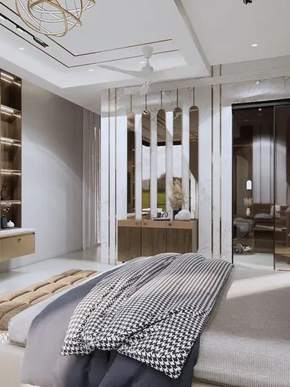 Another angle of the spacious master bedroom, showing the reflective wall panels that create a sense of depth. The design is clean and modern, with a focus on high-quality materials and finishes.