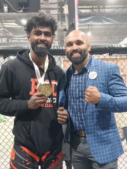 Here I am with another of our international athletes, Arjun "The Kshatriya," after he won his medal. We are a team of winners.