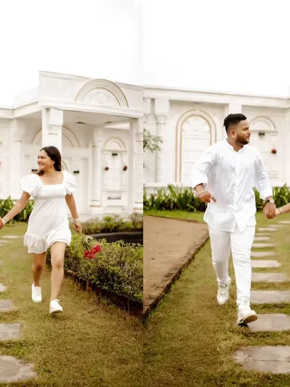 Running hand-in-hand through a pristine white garden. The all-white theme of the location and their outfits creates a pure, elegant, and joyful pre-wedding photograph.