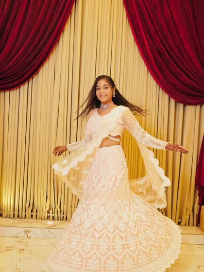 Another shot of the client twirling in the white chikankari lehenga.