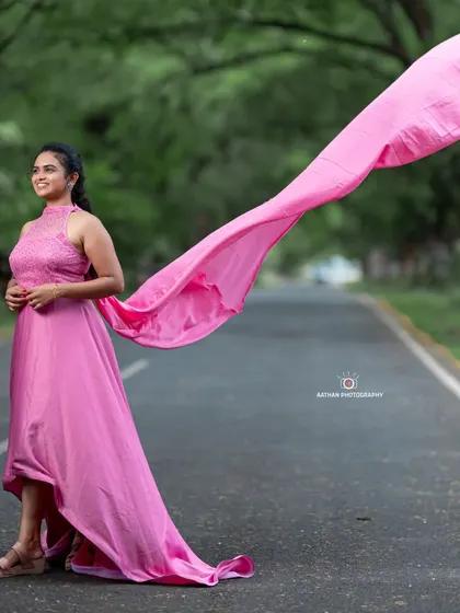 The lightweight fabric of this pink gown's trail makes it easy for photographers to capture stunning, flowing motion shots.