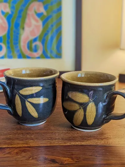 Tea time is made more special with my nature-inspired Lantana teacups. The dark glaze with the contrasting leaf pattern creates a sophisticated look. They are perfect for adding a touch of elegance to your daily routine.
