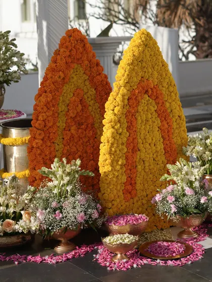 Large, cone-shaped structures made entirely of yellow and orange marigolds served as a stunning and traditional focal point.